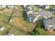 Aerial view of a fenced-in backyard, featuring a playset, shed, and ample green space at 25 Gallery Park Dr, Franklinton, NC 27525