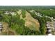 Aerial view showcasing a well-maintained golf course surrounded by lush trees and residential homes at 25 Gallery Park Dr, Franklinton, NC 27525