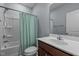 Clean bathroom showcasing a well-maintained vanity, toilet, and a shower-tub combination with a decorative curtain at 25 Gallery Park Dr, Franklinton, NC 27525
