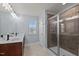 Bathroom featuring a walk-in shower with brown tiling, and a double vanity at 25 Gallery Park Dr, Franklinton, NC 27525