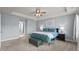 Bright and inviting bedroom featuring a tray ceiling, ceiling fan, and ample natural light through large windows at 25 Gallery Park Dr, Franklinton, NC 27525