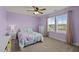 Cozy bedroom featuring a comfortable bed, a ceiling fan, and large windows at 25 Gallery Park Dr, Franklinton, NC 27525