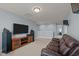 Spacious bonus room with a plush sofa, flat-screen TV, and speakers, ideal for movie nights and relaxation at 25 Gallery Park Dr, Franklinton, NC 27525