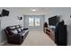 Cozy bonus room with plush seating, a large flat-screen TV, and surround sound speakers for entertainment at 25 Gallery Park Dr, Franklinton, NC 27525