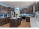 Stylish kitchen with dark cabinetry, stainless appliances, central island, and sleek countertops at 25 Gallery Park Dr, Franklinton, NC 27525