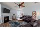Cozy living room with a fireplace, ceiling fan, leather furniture, and carpet at 25 Gallery Park Dr, Franklinton, NC 27525