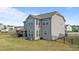 Back exterior view of a two-story house with a covered patio and expansive backyard at 25 Gallery Park Dr, Franklinton, NC 27525