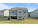 Home's back exterior showing a covered patio and a large, fenced backyard at 25 Gallery Park Dr, Franklinton, NC 27525