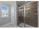 A tiled walk-in shower with seamless glass doors is a prominent feature of this bathroom at 25 Gallery Park Dr, Franklinton, NC 27525