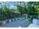 Backyard with gardening beds, greenhouse, gravel, and stone paver stair access at 2511 Bexley Ave, Durham, NC 27707