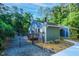 Backyard with a black fence, mature trees, and well-maintained grounds at 2511 Bexley Ave, Durham, NC 27707