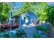 Exterior view of home featuring a deck, patio, and garden beds in a landscaped backyard at 2511 Bexley Ave, Durham, NC 27707