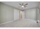 Bright bedroom featuring neutral walls, gray carpet, ceiling fan, closet, and ensuite door at 2511 Bexley Ave, Durham, NC 27707