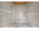 Walk-in closet with built-in shelving and modern marble floors, maximizing storage space at 2511 Bexley Ave, Durham, NC 27707