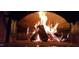 Inviting brick fireplace with burning wood creating a cozy ambiance at 2511 Bexley Ave, Durham, NC 27707