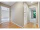 Hallway with hardwood floors connecting to bedrooms and bathrooms with carpeted floors at 2511 Bexley Ave, Durham, NC 27707