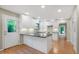 Modern kitchen with white cabinets, granite countertops, stainless steel appliances, and hardwood flooring at 2511 Bexley Ave, Durham, NC 27707