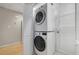Closet featuring stacked washer and dryer, white trim and built-in storage shelving at 2511 Bexley Ave, Durham, NC 27707