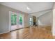 Bright living room with a brick fireplace, hardwood floors, and access to a patio at 2511 Bexley Ave, Durham, NC 27707