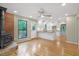 Living room featuring a brick fireplace, hardwood floors, and a ceiling fan at 2511 Bexley Ave, Durham, NC 27707