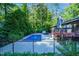 A beautiful fenced-in pool with a stone outdoor oven and patio area at 2511 Bexley Ave, Durham, NC 27707