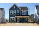 New two-story home with blue siding and white trim under construction on a sunny day at 261 Marvel Dr # 136, Rolesville, NC 27571