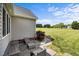 Cozy back patio with seating overlooks an expansive lawn and vibrant landscaping for serene outdoor living at 281 Derwin Dr, Timberlake, NC 27583
