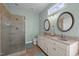 Bathroom featuring double sinks, granite countertop, a tiled shower, and modern fixtures at 281 Derwin Dr, Timberlake, NC 27583