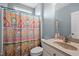 Cozy bathroom featuring colorful shower curtain and a neutral sink and vanity area at 281 Derwin Dr, Timberlake, NC 27583