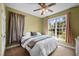 Bright bedroom with a ceiling fan and large window offering abundant natural light and pretty curtain decor at 281 Derwin Dr, Timberlake, NC 27583