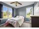 Comfortable bedroom featuring two large windows providing scenic views of the outdoors at 281 Derwin Dr, Timberlake, NC 27583