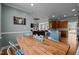 Open concept dining area with rustic wooden table and views into the kitchen and living area at 281 Derwin Dr, Timberlake, NC 27583