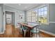 Sunny dining room features a wooden table, view of backyard, and access to a laundry room at 281 Derwin Dr, Timberlake, NC 27583