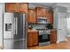 Modern kitchen with stainless steel appliances and custom wood cabinets at 281 Derwin Dr, Timberlake, NC 27583