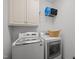 Bright laundry area with white cabinets, modern washer, and dryer for convenient home chores at 281 Derwin Dr, Timberlake, NC 27583