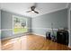 Bright living room featuring hardwood floors and a large window showcasing the outdoors at 281 Derwin Dr, Timberlake, NC 27583