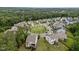 Aerial view of a neighborhood featuring a landscaped traffic circle and lush green trees at 302 Kinney Glenn Ct, Durham, NC 27713