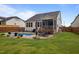 Beautiful backyard featuring an in-ground pool, lounge area, and screened in porch at 302 Kinney Glenn Ct, Durham, NC 27713
