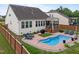 Expansive backyard featuring an in-ground pool, sun loungers, screened porch at 302 Kinney Glenn Ct, Durham, NC 27713