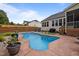 Lush backyard featuring a private pool, patio area, and manicured landscaping at 302 Kinney Glenn Ct, Durham, NC 27713