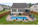 Wide backyard view of private pool, back of house with screened porch and privacy fence at 302 Kinney Glenn Ct, Durham, NC 27713