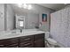 Cozy bathroom features a white vanity and colorful polka dot shower curtain at 302 Kinney Glenn Ct, Durham, NC 27713