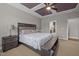 Bedroom with tray ceiling, ceiling fan, and en suite bathroom entrance at 302 Kinney Glenn Ct, Durham, NC 27713