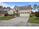 Charming two-story home with a front-facing two car garage, stone accents, and landscaped yard at 302 Kinney Glenn Ct, Durham, NC 27713