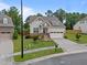 A well-maintained two-story home with a two car garage, landscaped yard, and inviting front porch at 302 Kinney Glenn Ct, Durham, NC 27713