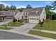 Charming two-story home featuring a two car garage, manicured lawn, and inviting front entryway at 302 Kinney Glenn Ct, Durham, NC 27713