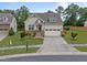 Beautiful home featuring a well-manicured lawn, stone accents, and a convenient two-car garage at 302 Kinney Glenn Ct, Durham, NC 27713