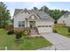 Charming single-Gathering home with a well-manicured lawn, stone accents, and a two-car garage at 302 Kinney Glenn Ct, Durham, NC 27713