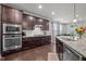 Modern kitchen featuring stainless steel appliances, granite countertops, and stylish cabinetry at 302 Kinney Glenn Ct, Durham, NC 27713
