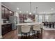 Kitchen island with granite countertops, pendant lighting, and seating for casual dining at 302 Kinney Glenn Ct, Durham, NC 27713